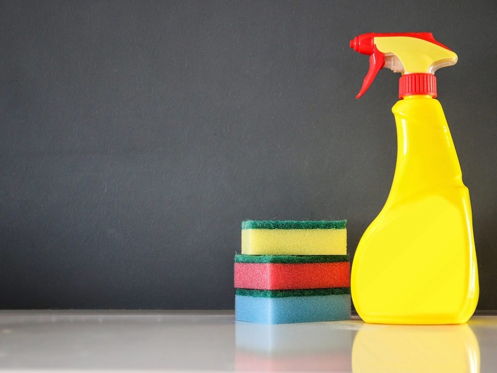 A spray bottle and stacked sponges ready for a clean