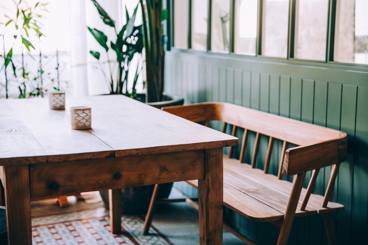 A clean dining table and bench in a home