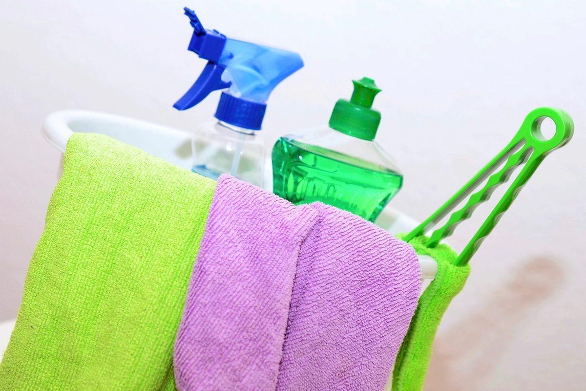 Folded microfibre cloths and cleaning sprays laid out