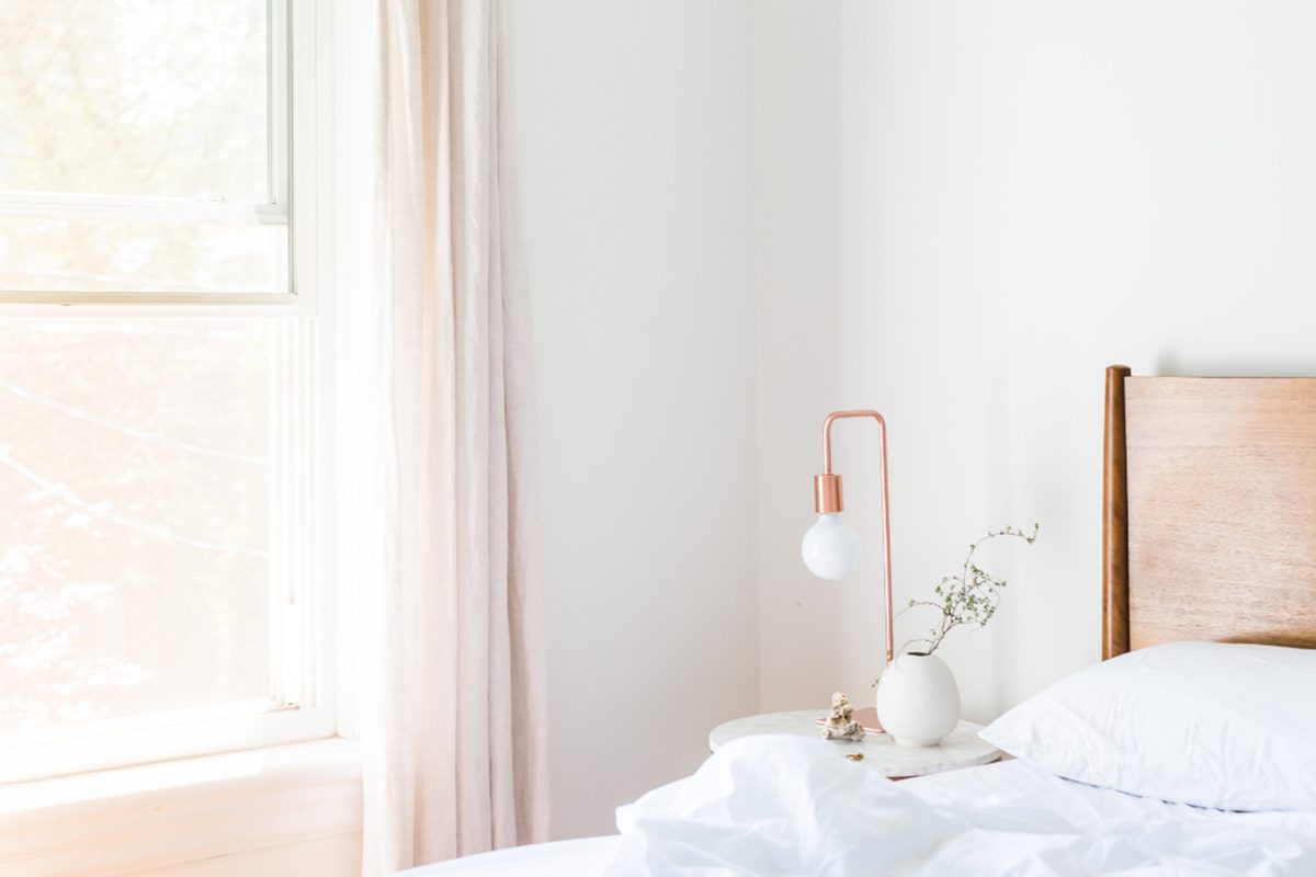 A made bed in a calm, clean bedroom