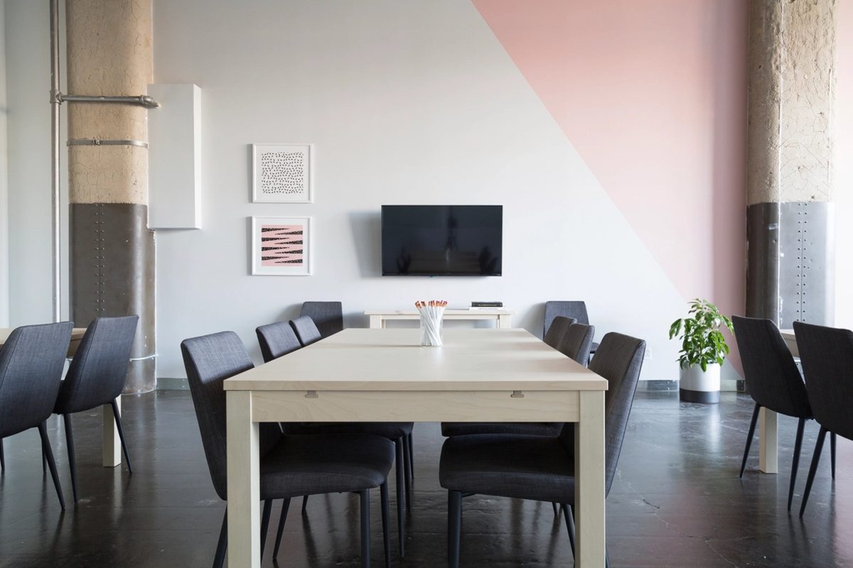 A tidy meeting room with a long table and chairs